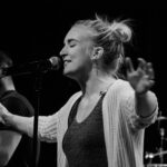 woman standing front of microphone